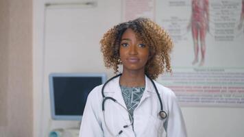 African american female doctor removes a medical mask in hospital with ultrasound devices on background. End of quarantine. Stop virus video