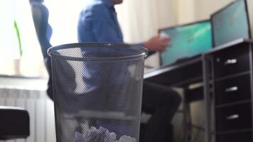 Office employee tossing away crumpled paper into trash can. Throw crumpled into the trash video