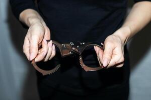 hand squeezing metal handcuffs, the concept of freedom justice. photo
