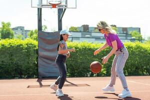 Mother and daughter playing basketball photo
