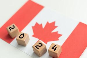 2024, Canada, Canada flag with date block, Concept, Important events for Canada in the new year, election, economy, social activities, central bank, Canada foreign policy photo