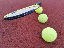 tennis racket with a tennis ball on a tennis court photo