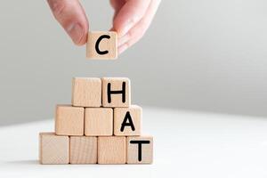 Word Chat on board game square plastic tile pieces, isolated on a white background. photo