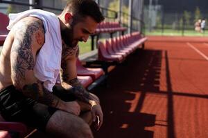 Young sportsman take a break after training. Fitness, sport and lifestyle concept photo