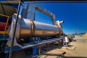 Outdoor asphalt mixes station. Loading equipment. Asphalt mixture. Selective focus. photo