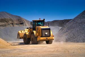 Heavy duty machinery working on highway construction site. Bulldozer, dumper truck, tractor. photo