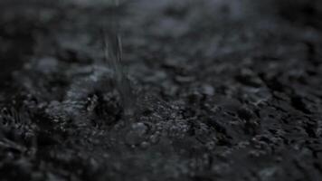 Slow motion heavy rain water drops on surface street video
