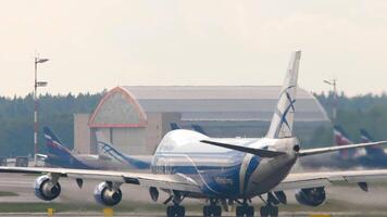 MOSCOW, RUSSIAN FEDERATION - JULY 30, 2021. Boeing 747 AirBridgeCargo acceleration for takeoff. Huge cargo jumbo jet departure video