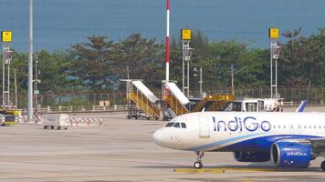 PHUKET, THAILAND - FEBRUARY 26, 2023. Passenger plane Airbus A320, VT-IJB of IndiGo on the airfield, taxiing to the terminal. Airplane Indian Airlines arrival in Phuket video