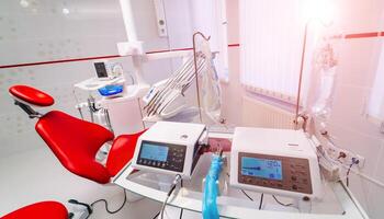 dentistry, medicine, medical equipment and stomatology concept - interior of new modern dental clinic office with chair photo