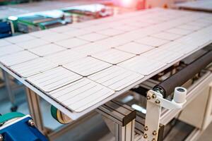 Production of solar panels. Modern industrial equipment manufacturing high-tech solar energy components photo