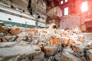 Destroyed interior of old factory. Large industrial hall of a repair station photo