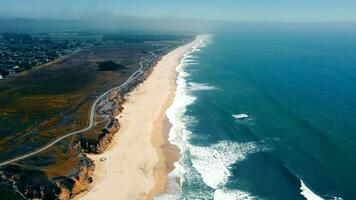 Aerial view Pacific beach without people. Coastline of a sandy beach of the Pacific Ocean in California. video