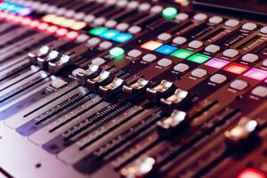 Professional studio equipment for sound mixing. Close-up view of audio control buttons. Media production studio. Music record service photo