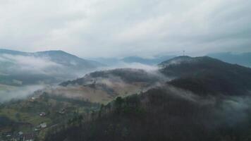 Aerial view of foggy and cloudy hills and radio tower in Slovakia video