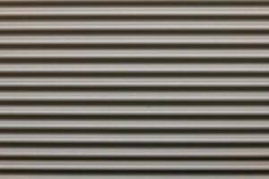 a gray corrugated iron wall in the city photo