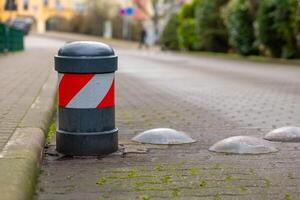 a bollard on a road to warn traffic photo