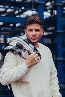 an attractive young man with a white sweater photo