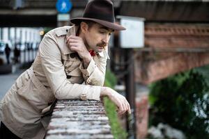 Vintage detective smoking a sigarette and looking depressed photo