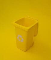 Yellow Trash Can on a Yellow Background. photo