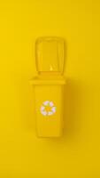 A Yellow Trash Can With a Recyclable Lid. photo