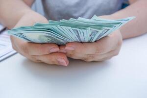 Person Holding Stack of Money, close up. photo