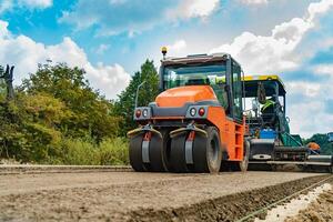 Roller, construction equipment, on the road repair site. Road repair machine with heavy vibration rollers compactor photo