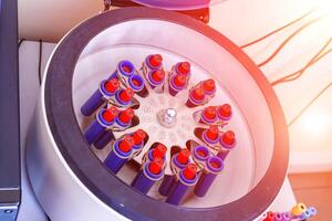 Medical laboratory centrifuge with test tubes with blood photo