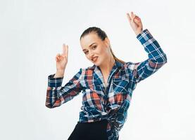 Excited pretty woman pointing fingers up with successful idea. Portrait of a happy cheerful girl showing peace gesture with two hands isolated over white background. photo