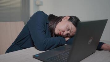 Close up view of overworked woman, tired from work, falls asleep at desk with laptop Unmotivated office worker lying on the desk, bored, wants to rest, insomnia concept. video