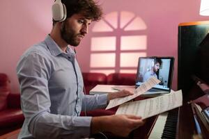 Man Teaching Piano Music Lesson With Remote Connection photo