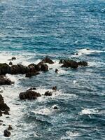 Rocks on ocean water in Calabria photo