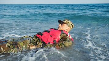 Military man with camouflage and life jacket as safety concept photo