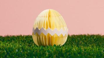 A yellow Easter Egg with a pink background photo