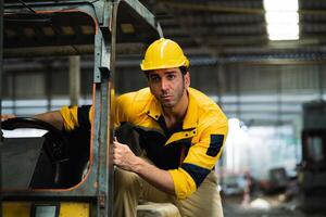 Male worker drives a forklift in an industrial container warehouse. Male factory worker driving a forklift in the factory Male engineer driving a car in a factory. photo