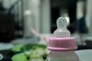 pink baby milk bottle blur background photo