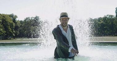 Happy Young Man Dancing in Water Fountain in Summer Time video