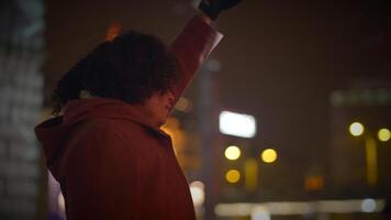 Happy Young Woman with Curly Hair Dancing Outside in the City Night Lights video