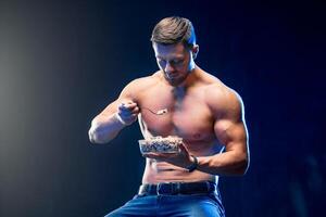 young muscular holding healthy food. Diet and healthy eating con photo