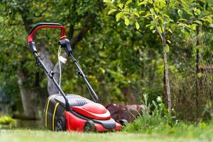 Lawn mower on green grass photo