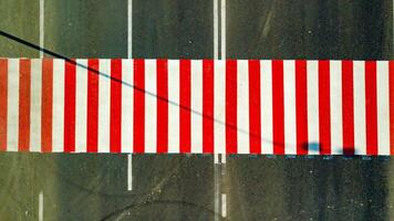 a new red and white colored pedestrian crossing is located on the highway. Aerial view photo