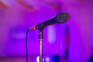 Microphone on the blurred background of the audio mixer of the musician. photo