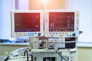 Two screens in operating room. Medical devices, Interior hospital design concept. Interior of operating room in modern clinic, monitor with tests closeup photo