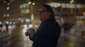 Male Traveler Taking Photo on Crowded Urban City Street at Night video