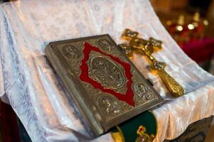 A Bible lying on the pulpit in a church. Wedding day. Glans day. Closeup. photo