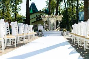 Outdoor wedding ceremony. Wedding ceremony with flowers outside in the garden photo
