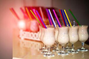 Cocktails on the bar counter. Glasses with delicious milk shakes on bar counter photo