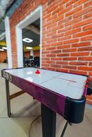 Air hockey table in office room. Relaxing games. Leasure time at work. Modern office concept. photo