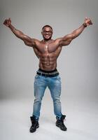 Muscular bodybuilder showing his muscles in studio. Handsome athletic man with naked torso posing for camera. photo