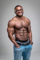 Handsome attractive bodybuilder posing for camera. Naked athletic man smilling in camera. photo